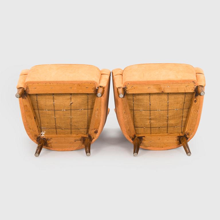 A pair of mid-20th century armchairs.