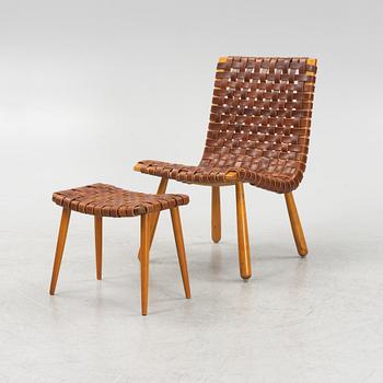 A mid 20th Century easy chair with a matched foot stool.