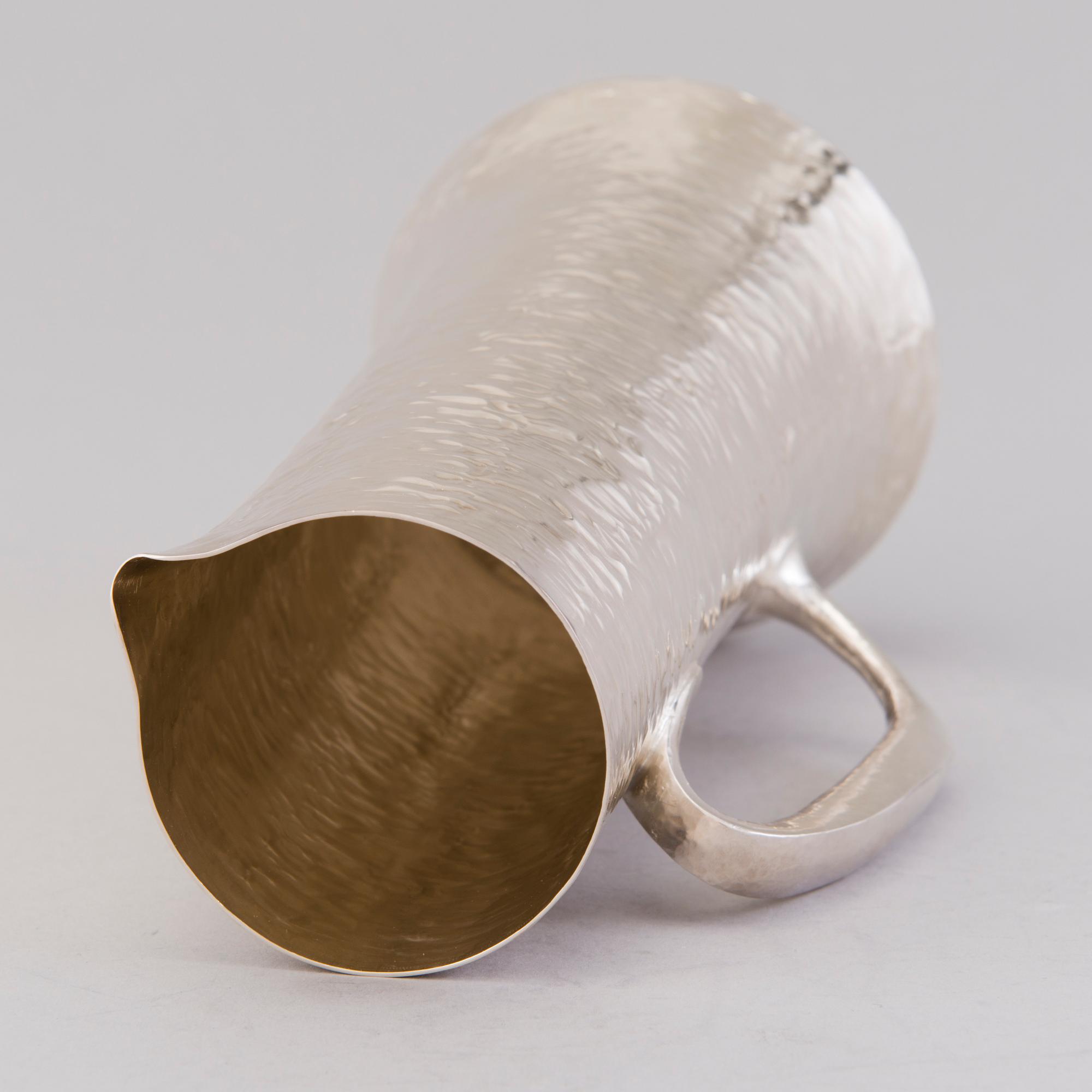 TAPIO WIRKKALA, a sterling silver pitcher and six beakers for Kultakeskus Hämeenlinna 1973.
