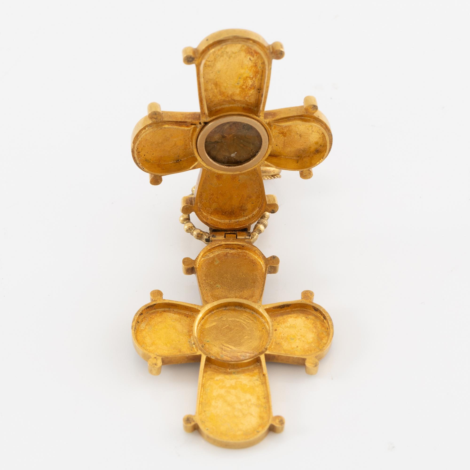 Cross 18K gold with enamel and white stone with relic compartment.