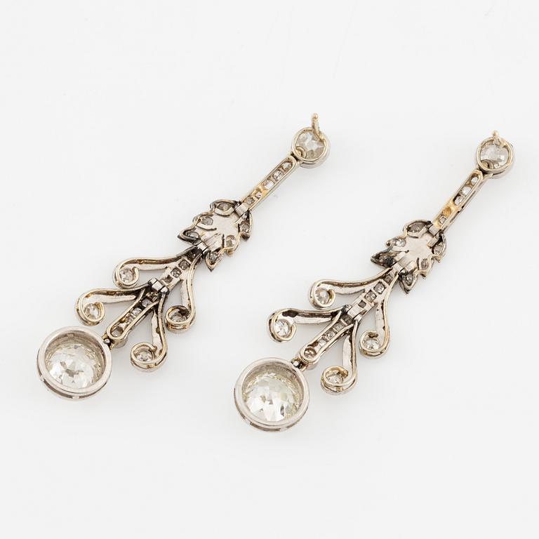A pair of earrings in platinum and 18K gold set with old- and rose-cut diamonds.