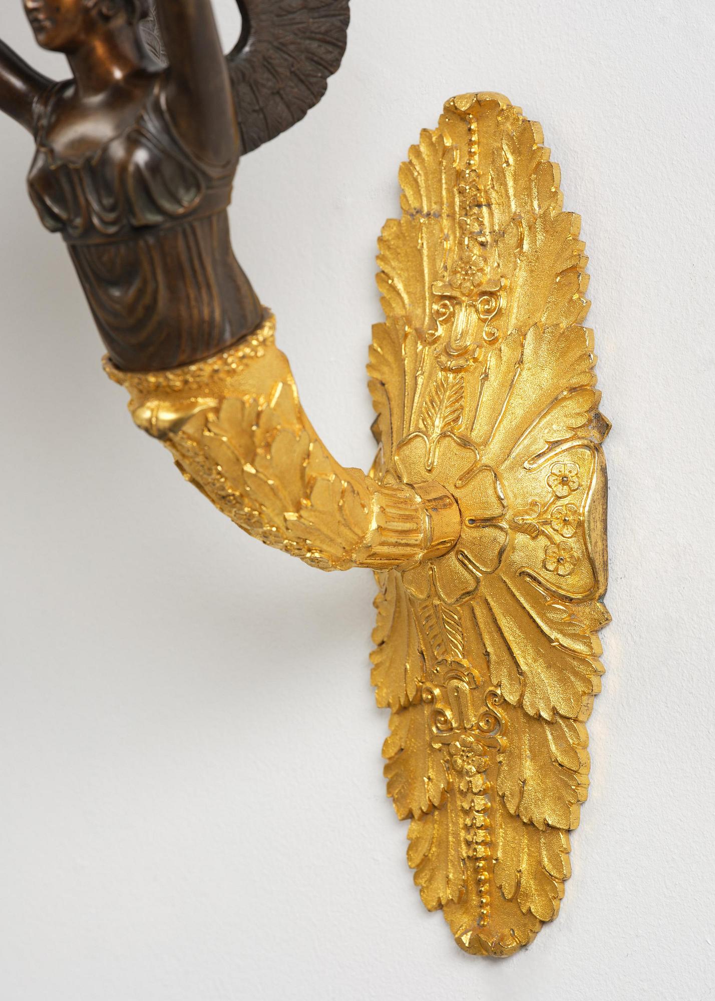 A pair of French Empire five-branch gilt and patinated bronze appliques, first part 19th century.