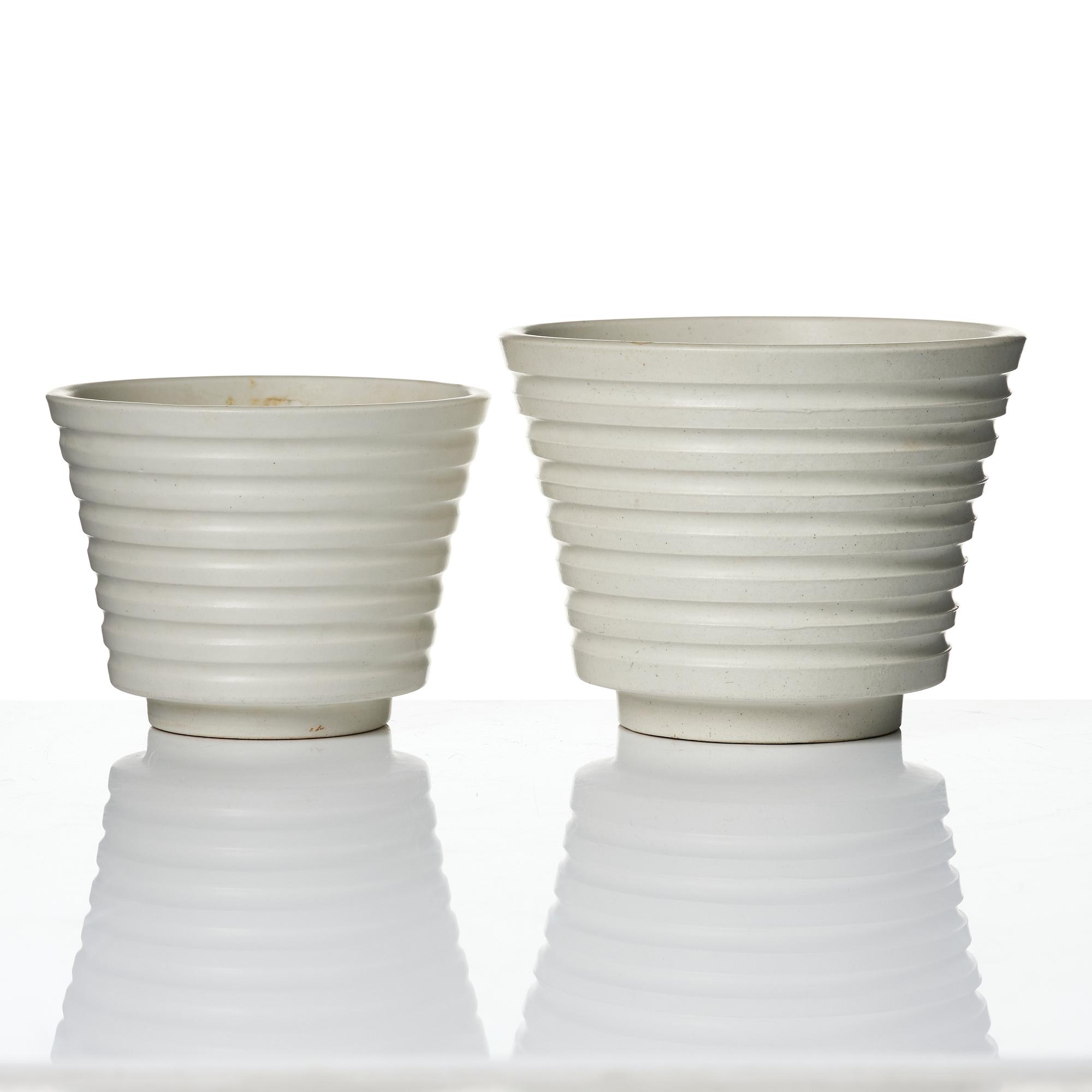 Wilhelm Kåge, A set of three ceramic flower pots, a vase and jar with lid,  Gustavsberg 1930s.