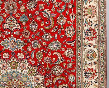 A signed Tabriz carpet, ca 336 x 223 cm.