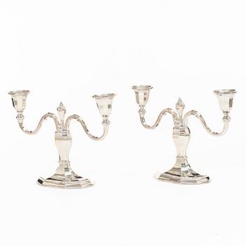 A pair of silver candelabras, with Swedish import marks, possibly mid20th century.