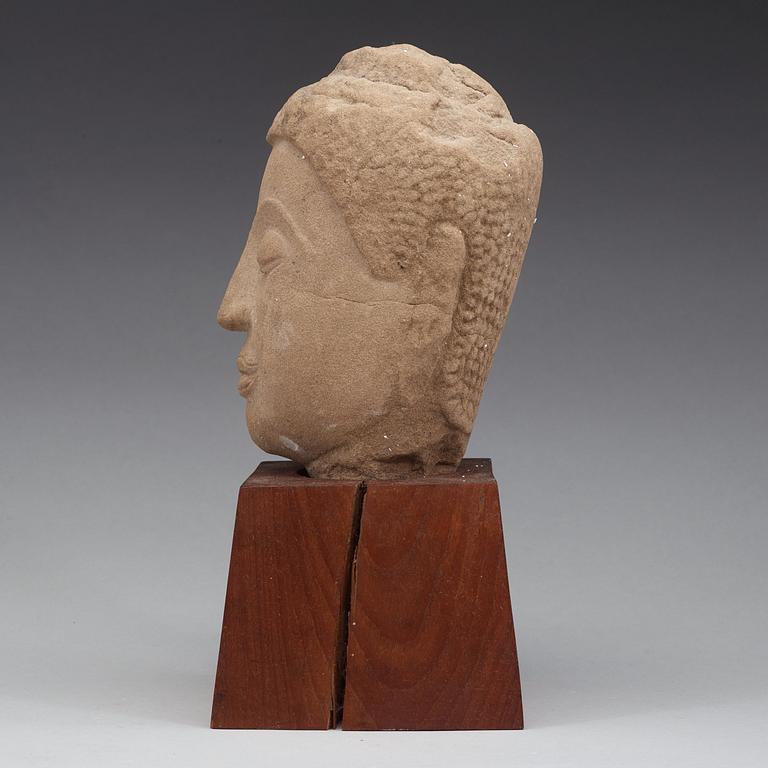 A Thai sandstone head of Buddha, 18/19th Century.