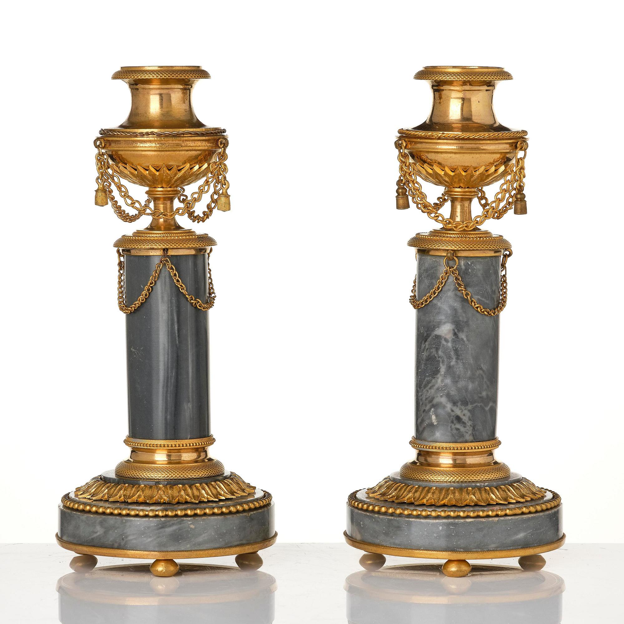 A pair of Louis XVI ormolu and Bleu turquin candlesticks.