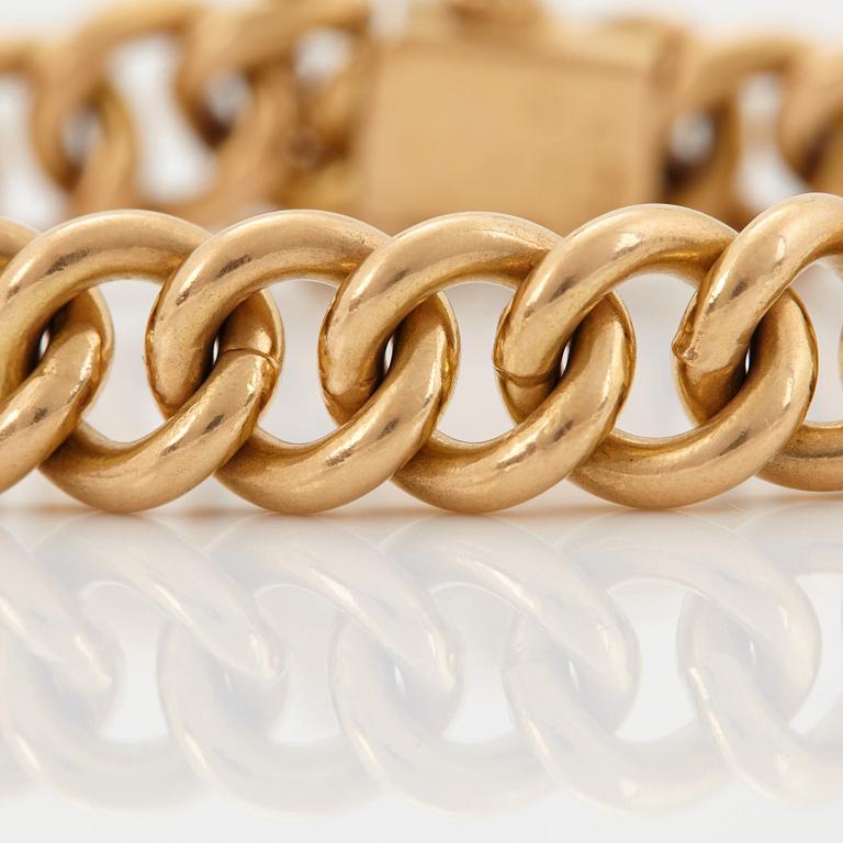 An 18K gold bracelet.