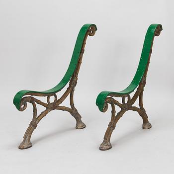 A pair of 20th-century cast iron garden sofa sides.