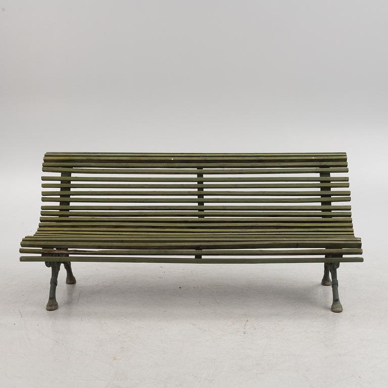 A cast iron-frame garden sofa, circa 1900.