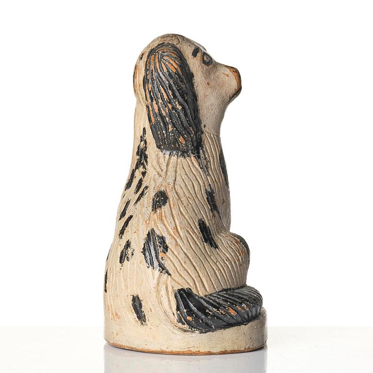 A Swedish wooden folk-art sculpture depicting a 'Staffordshire dog' ceramic figurine, 19th century.