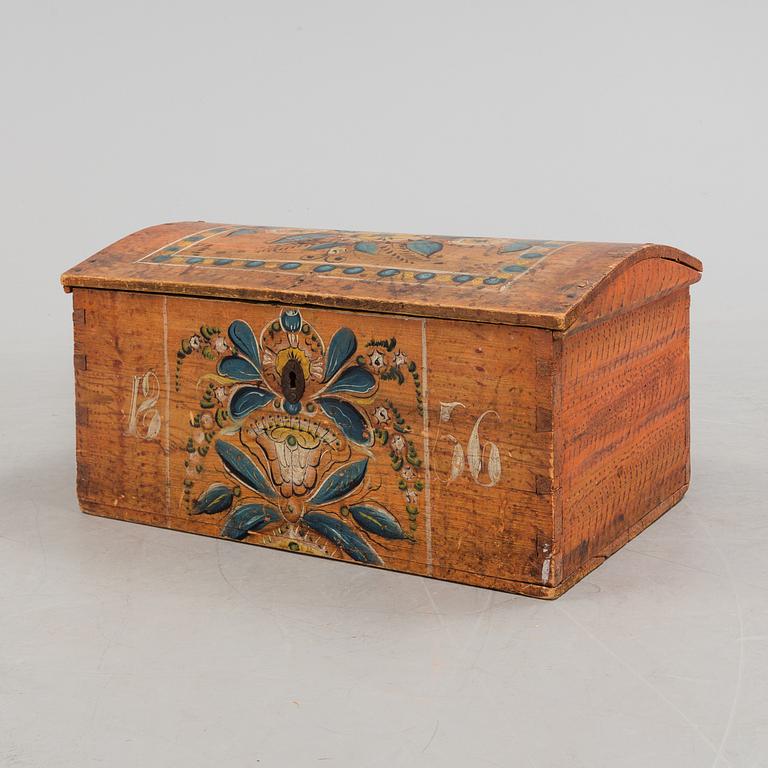 A wooden chest, dated 1856.