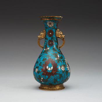 A cloisonné vase decorated with lotus-scrolls, and dragon- shaped gilded handles, Ming Dynasty (1368-1644).