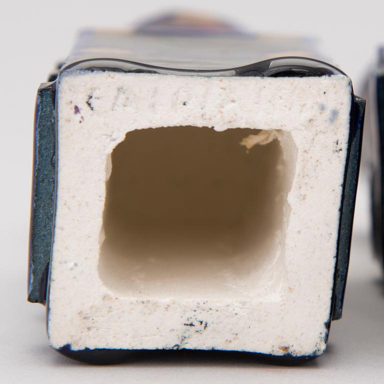 A pair of ceramic candlesticks signed Kaipiainen.