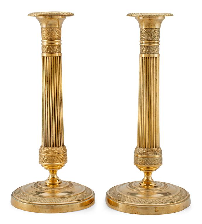 A PAIR OF EMPIRE CANDELSTICKS.