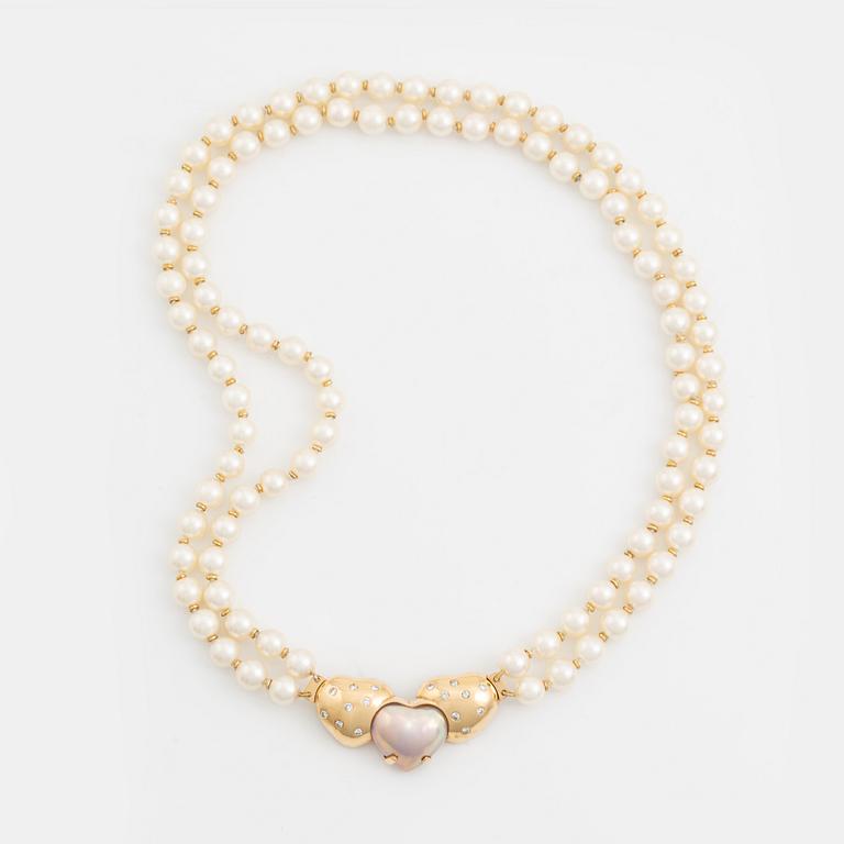 A two strand cultured pearl necklace with an 18K gold clasp with a half-pearl and round brilliant-cut diamonds.