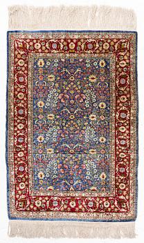 An Oriental silk rug, signed, c. 125 x 85 cm.