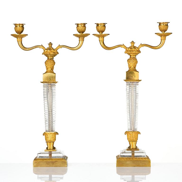 A pair of Empire ormolu and cut glass two-branch candelabra, Paris, early 19th century.