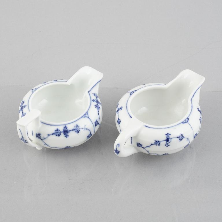 Two 'Musselmalet' porcelain creamers, Royal Copenhagen, one model 55, 19th century.