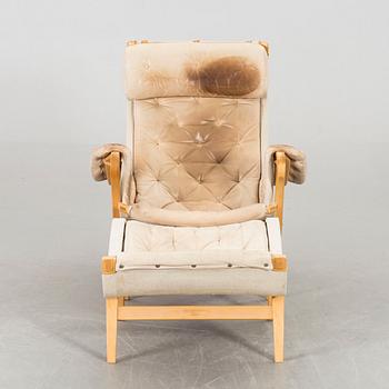 A BRUNO MATHSSON "PERNILLA" ARMCHAIR WITH STOOL.