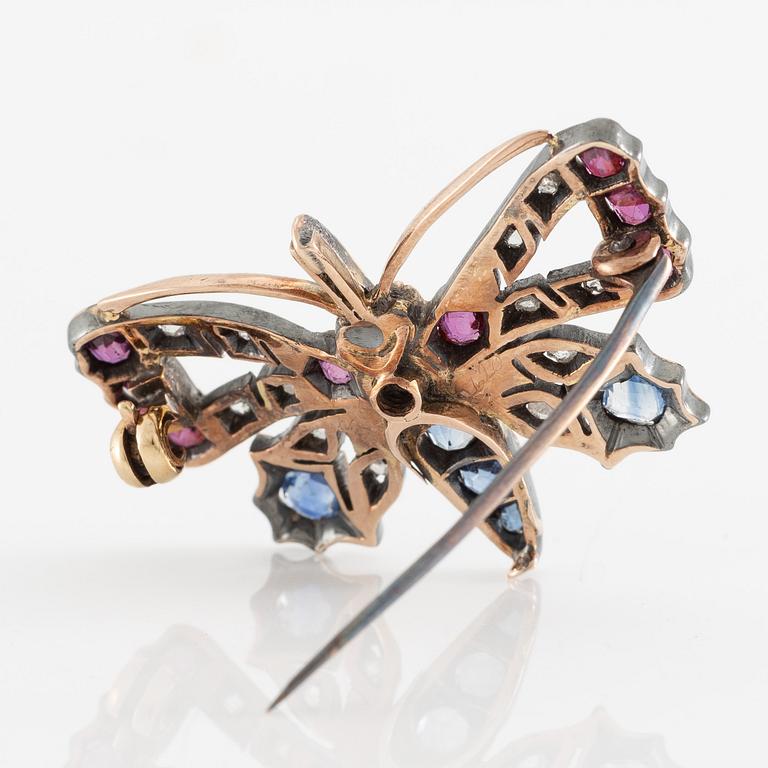 Brooch, in the form of a butterfly, set with sapphires and rubies and rose-cut diamonds.