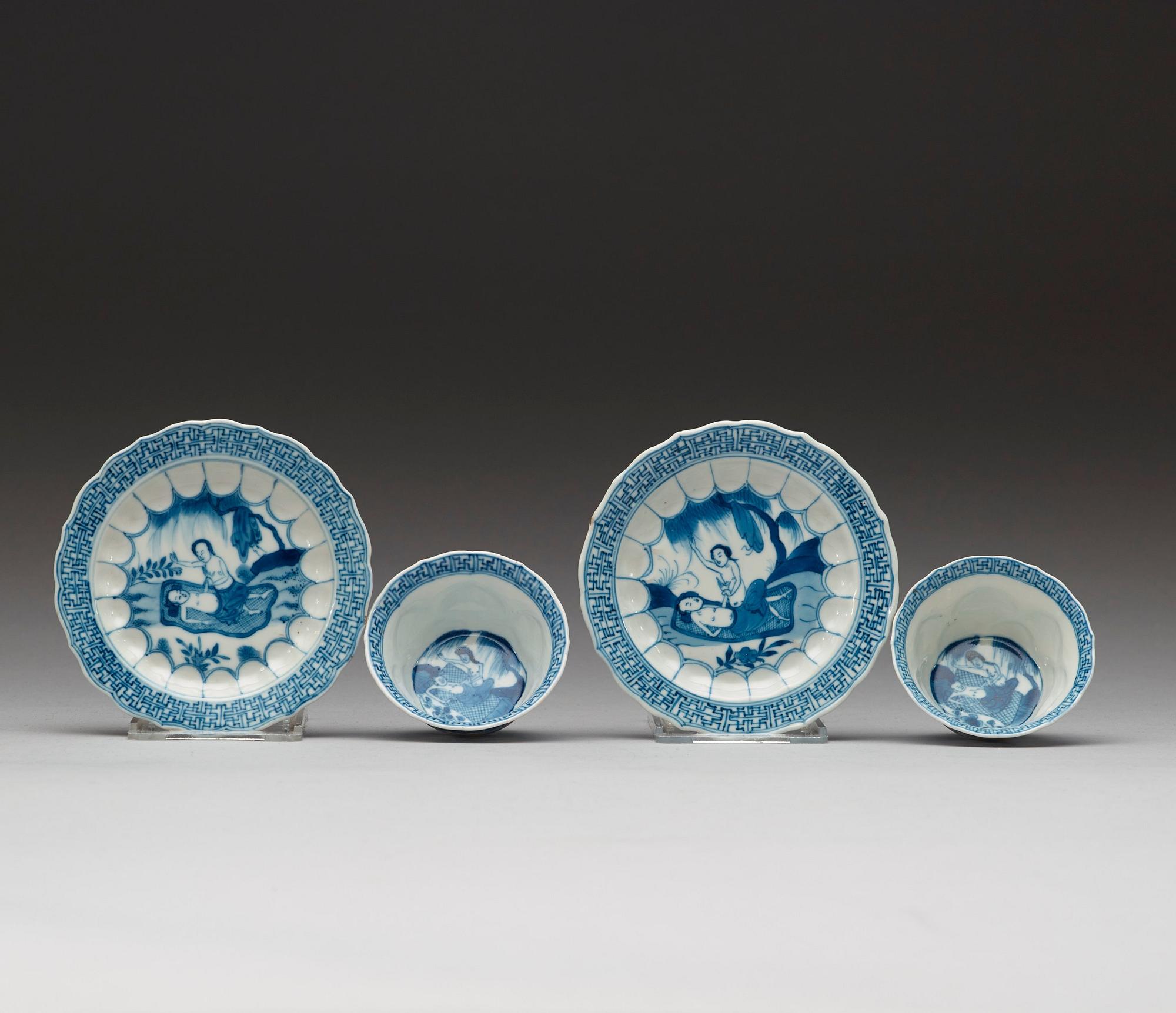A pair of blue and white "erotic" cups with saucers, Qing dynasty Kangxi (1662-1722).