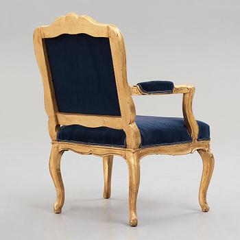 A Rococo mid 18th century armchair.