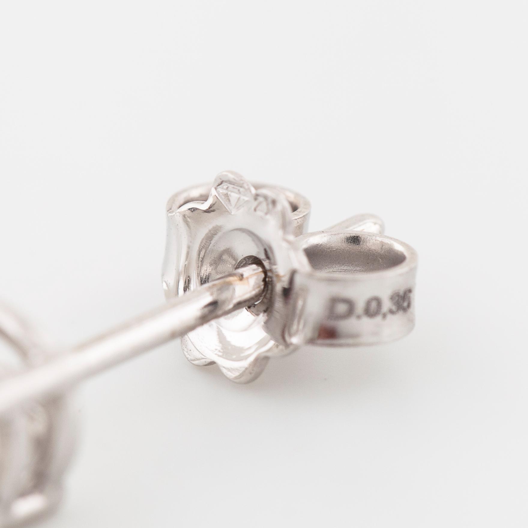A pair of brilliant cut diamond earrings.
