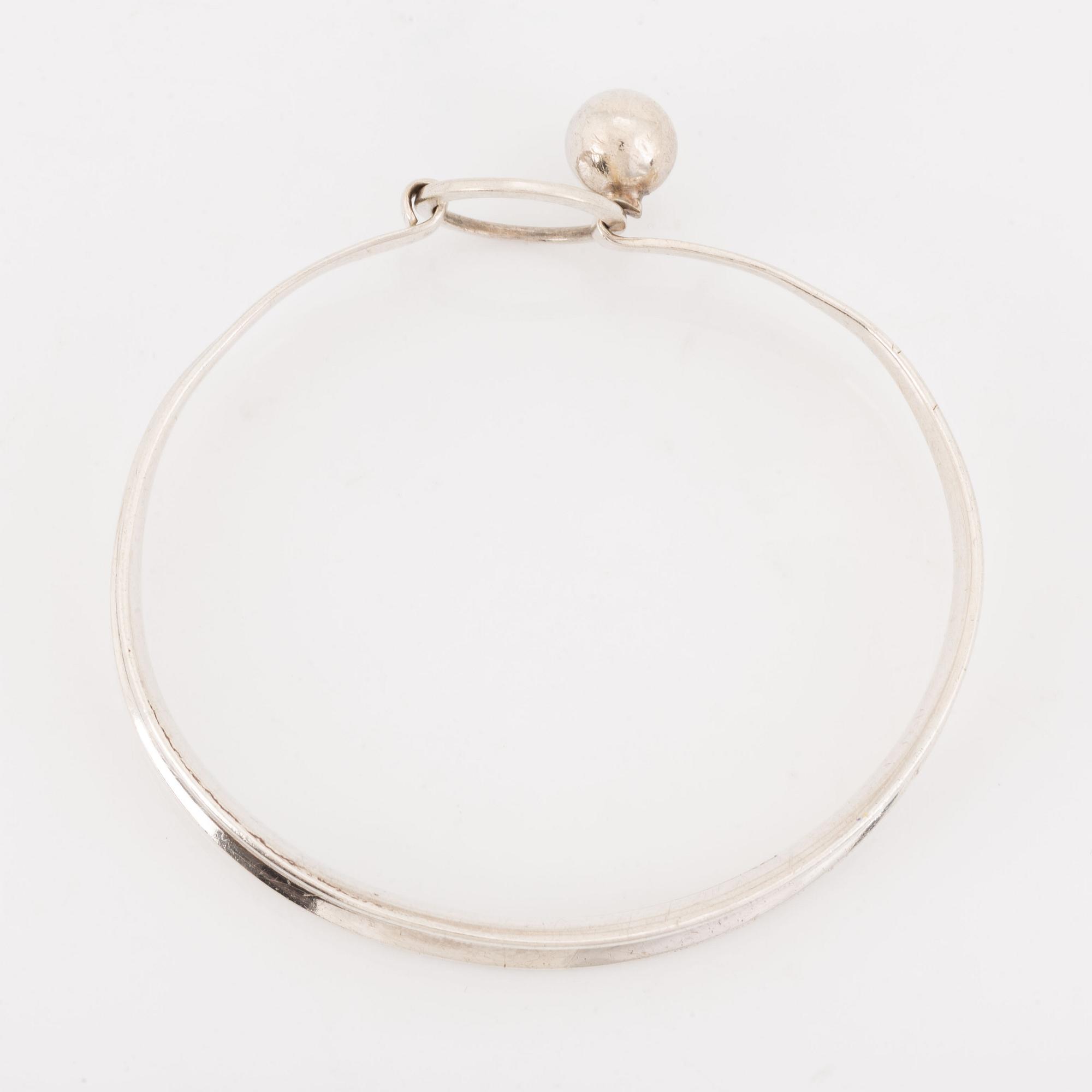 A silver Erik Granit bracelet.