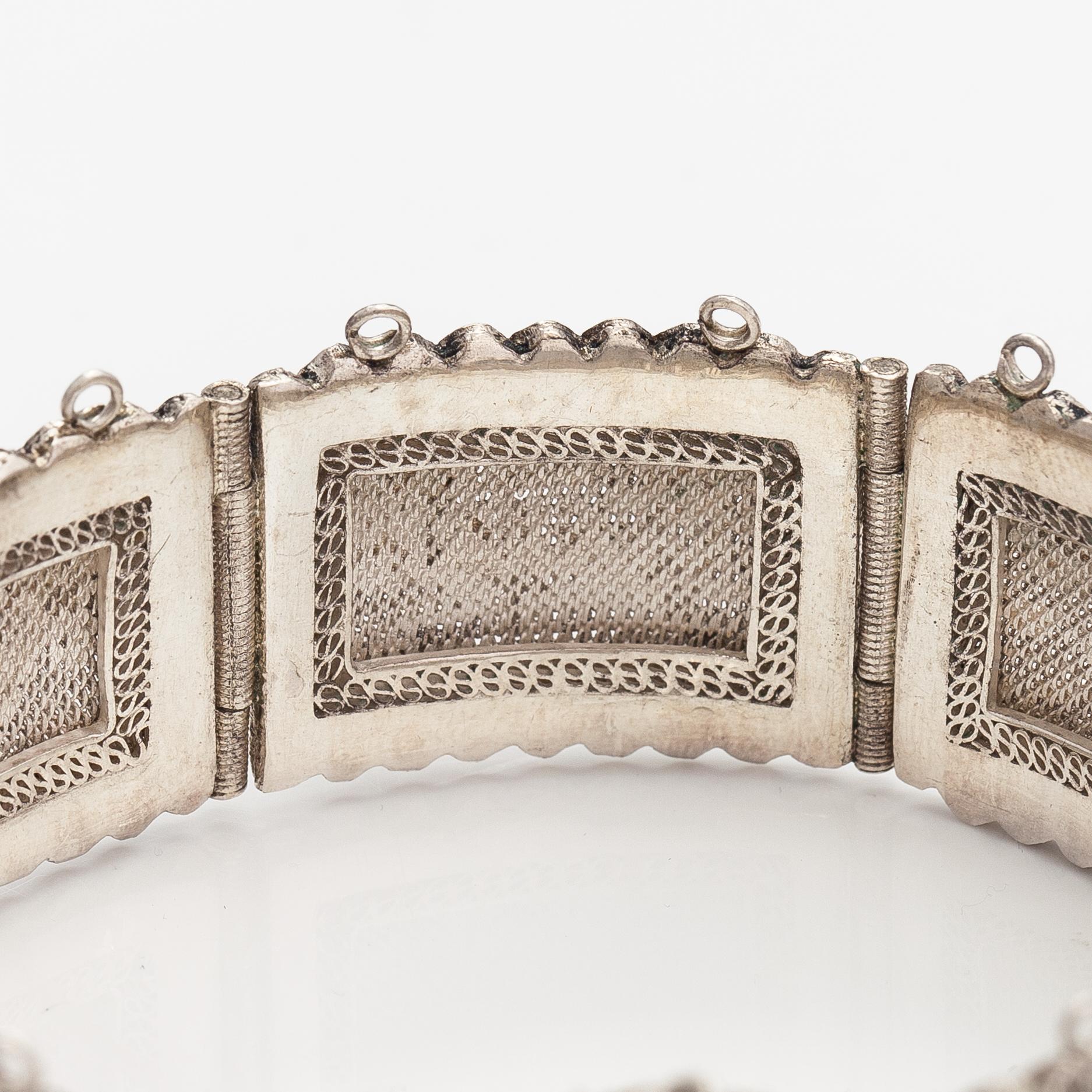 A silver bracelet and ring with turquoises. China.