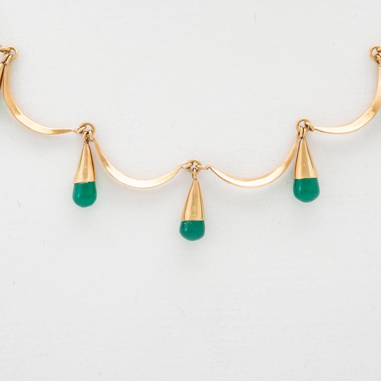 An 18K gold neckalce and a pair of earring set with green stones.