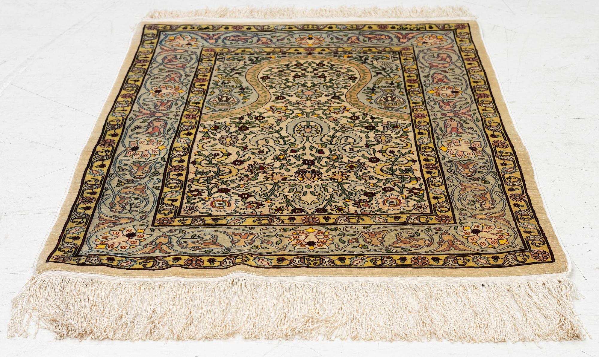 A silk Hereke rug, Turkey, approx. 82 x 58 cm.
