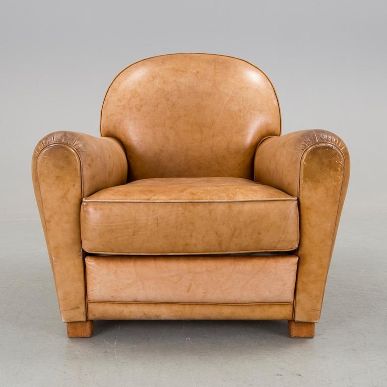 A brown leather armchair by grange, the second half of the 20th century.