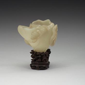 A nephrite brush washer, on a hardwood stand with silver inlay, Qing dynasty (1644-1912).