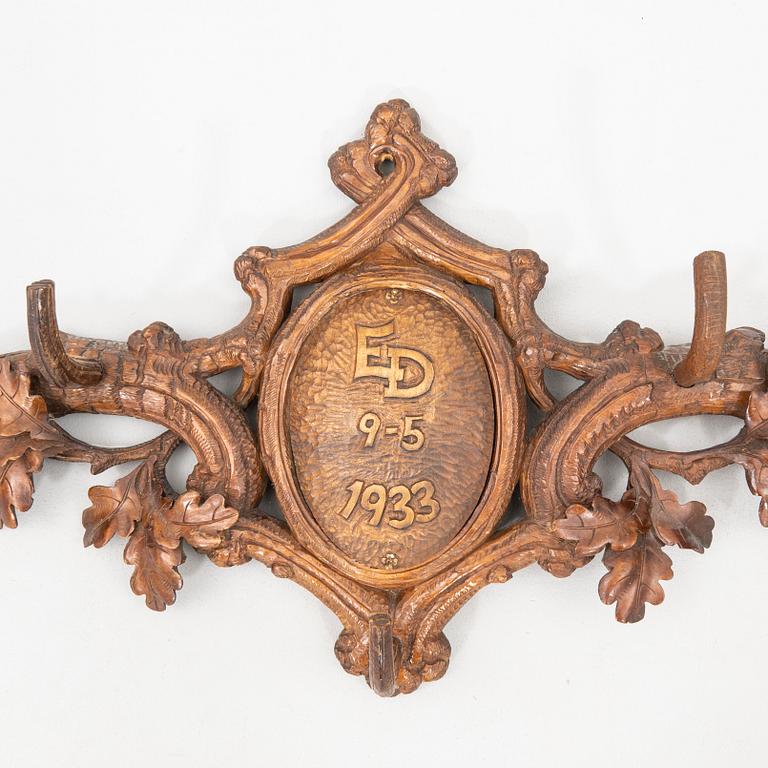 Wall-mounted coat rack dated 1933.