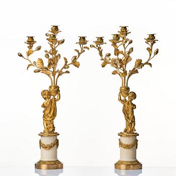 A pair of Louis XVI four light candelabra.