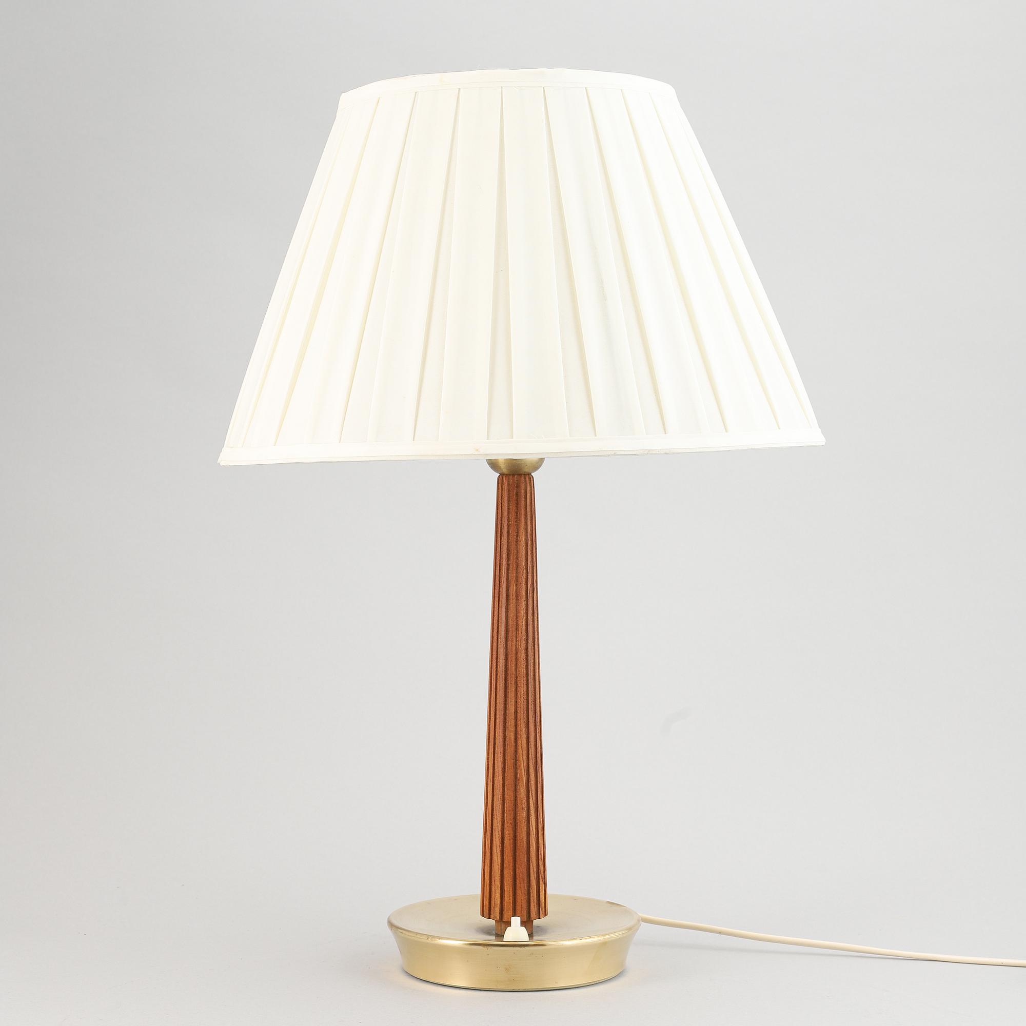 A brass and oak table light by Hans Bergström for ASEA, mid 20th Century.