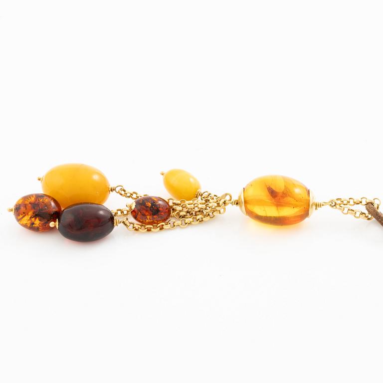 Necklace leather strap and 18K gold with amber.