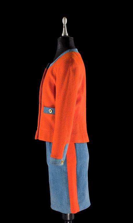 A two-piece orange bouclé and denim costume by Chanel.