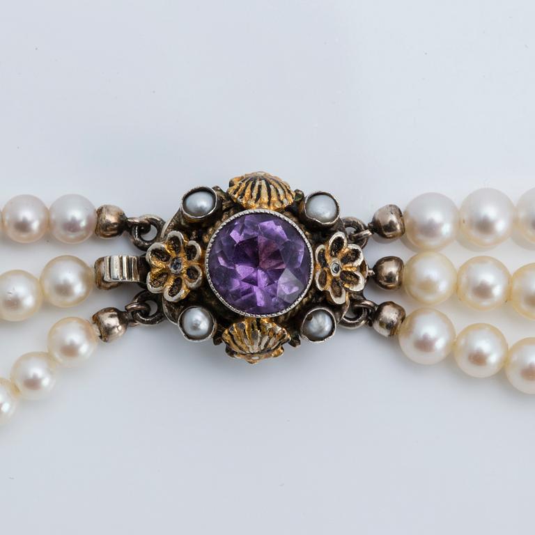 A cultured saltwater pearl collier with silver lock with purple faceted amethyst.