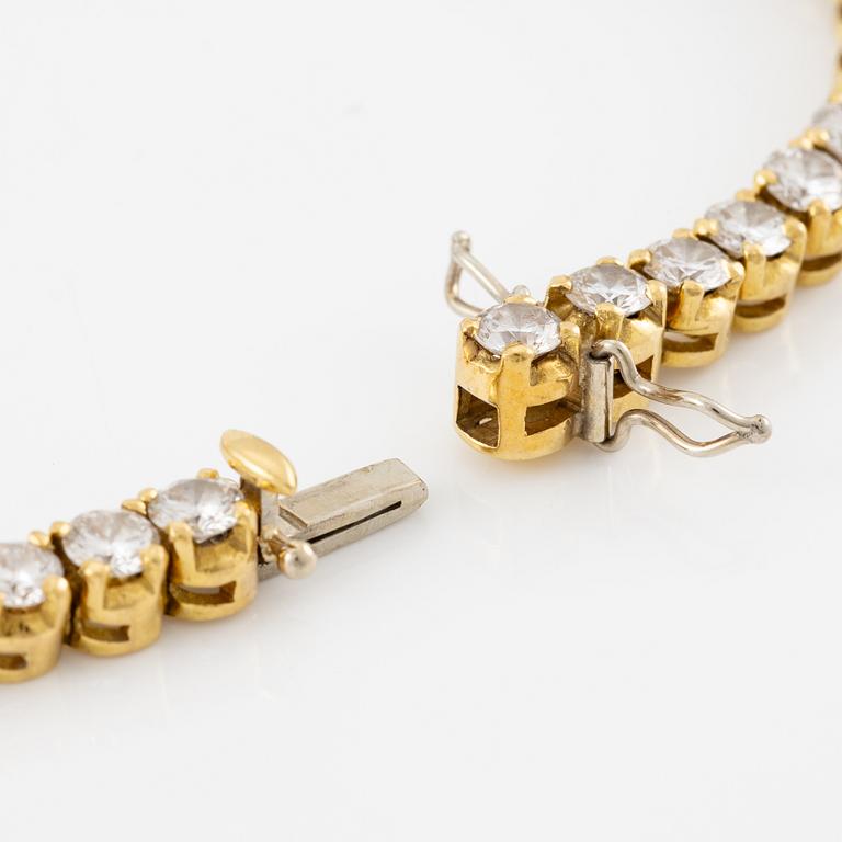 A tennis bracelet in 14K gold with round brilliant-cut diamonds.