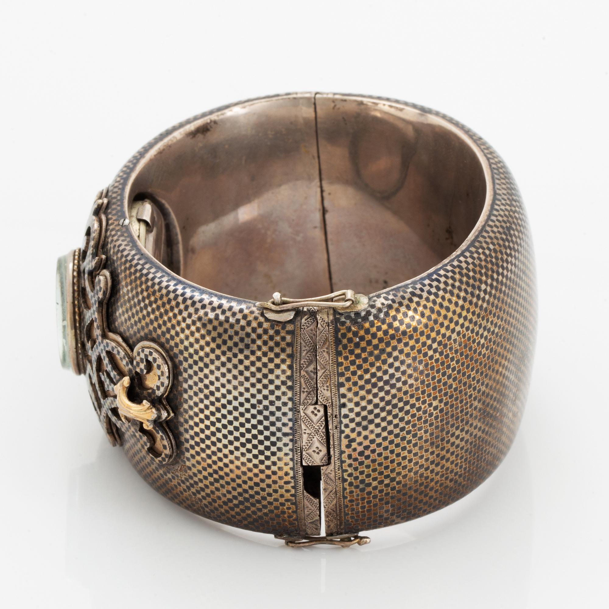 Silver bangle with watch.