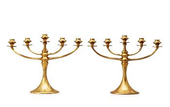 488. A pair of brass candelabra attributed to Bruno Paul, Germany, early 20th Century.