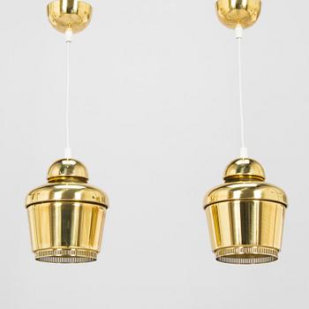 Alvar Aalto, A pair of  A 330, 'Golden Bell' pendant lights A330 for Artek, 2000s.