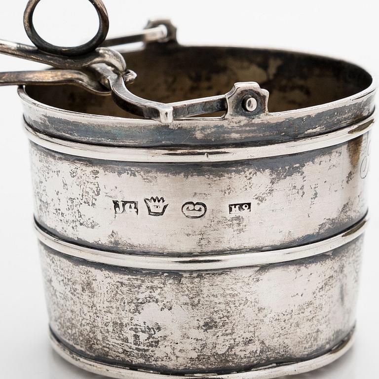 A silver sugar bowl, R. Mellin, Helsinki 1860, and two tea strainers, Kuopio and Porvoo, first half of the 19th century.