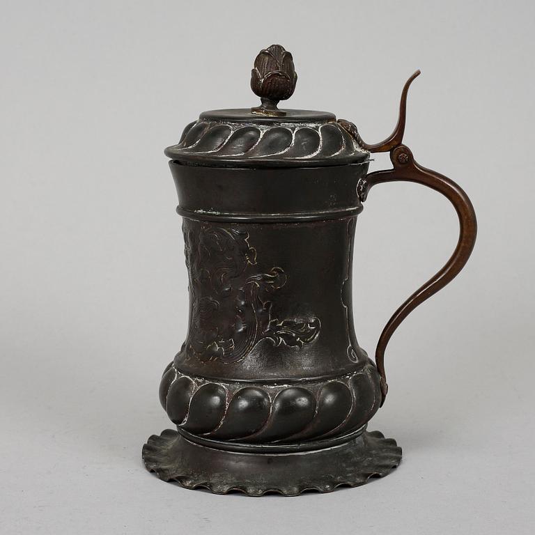 An 18th century copper mug.