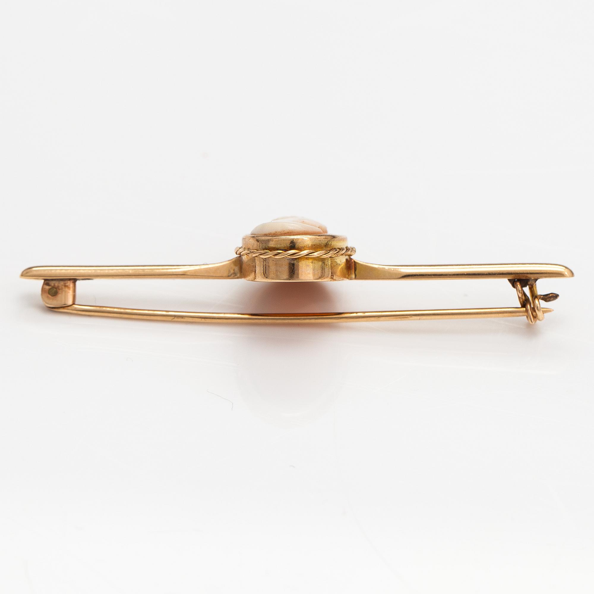 Two brooches and a ring, 14K and 18K gold and sea shell cameos.