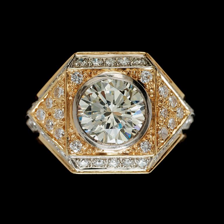 A brilliant-cut diamond ring. Center stone circa 2.95 cts. Surrounding diamonds total carat weight circa 1.50 cts.