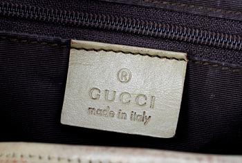 A beige monogram canvas handbag by Gucci.