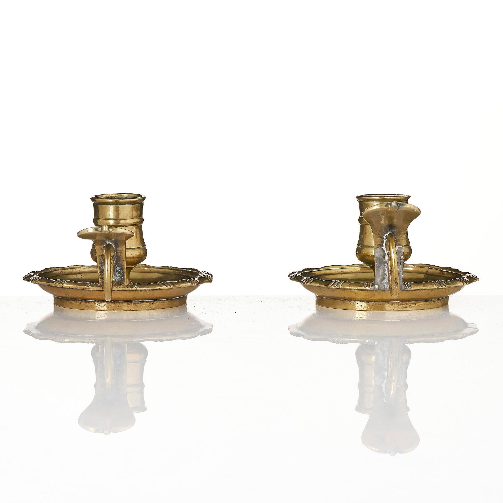 A pair of rococo brass candlesticks possibly by C. Liendenberg (active in Stockholm from 1745).